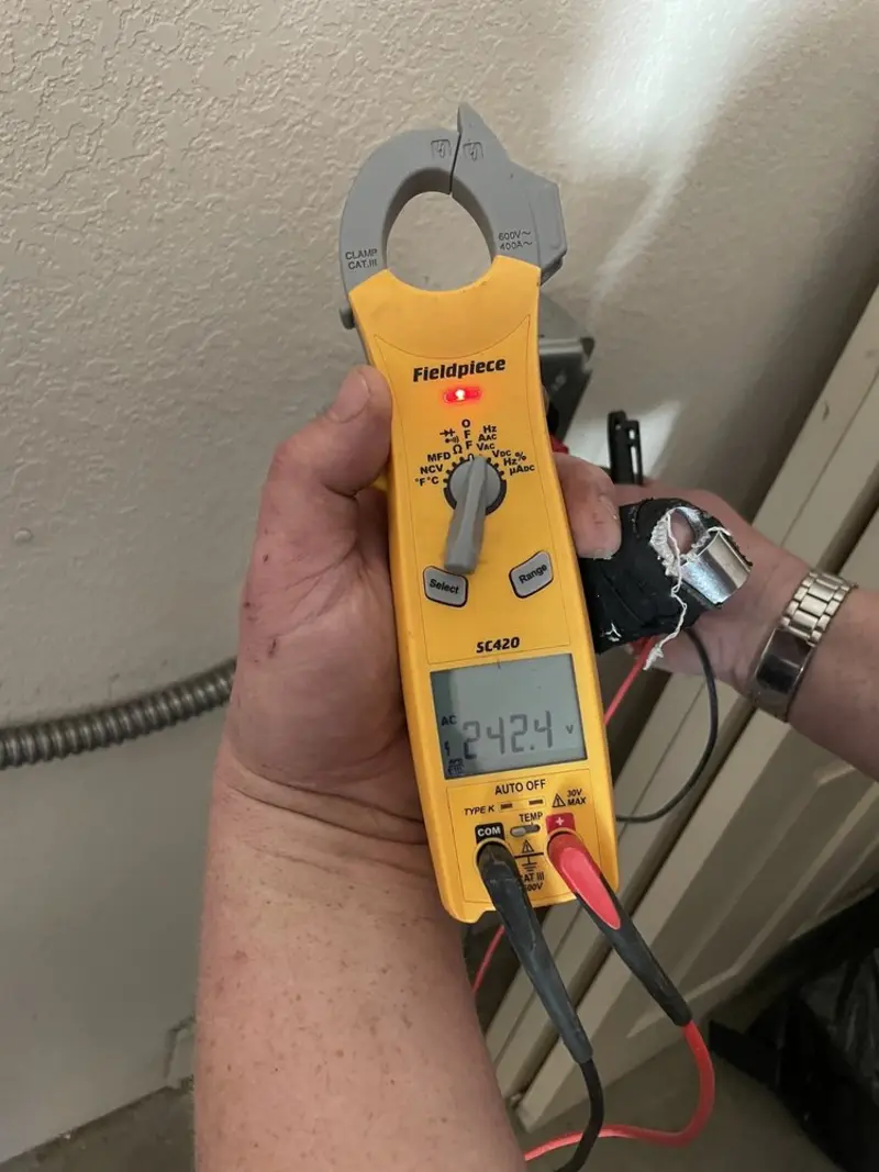 Voltage testing with clamp meter during Outlet Installation in Loganville